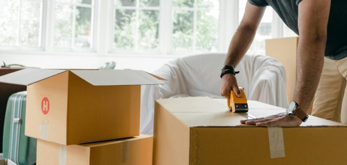 A person taping moving boxes